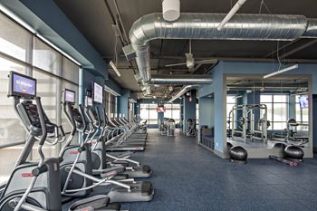 a section of cardio machines at the gym in Reveal Hackensack apartments
